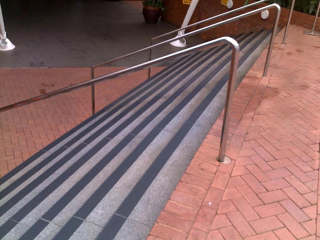 Anti-Slip Safety Tape applied on outdoor ramp with railings - non-slip grip strips for safety
