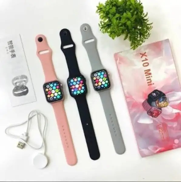 X10 Mini smart watches in pink black and grey with charging accessories